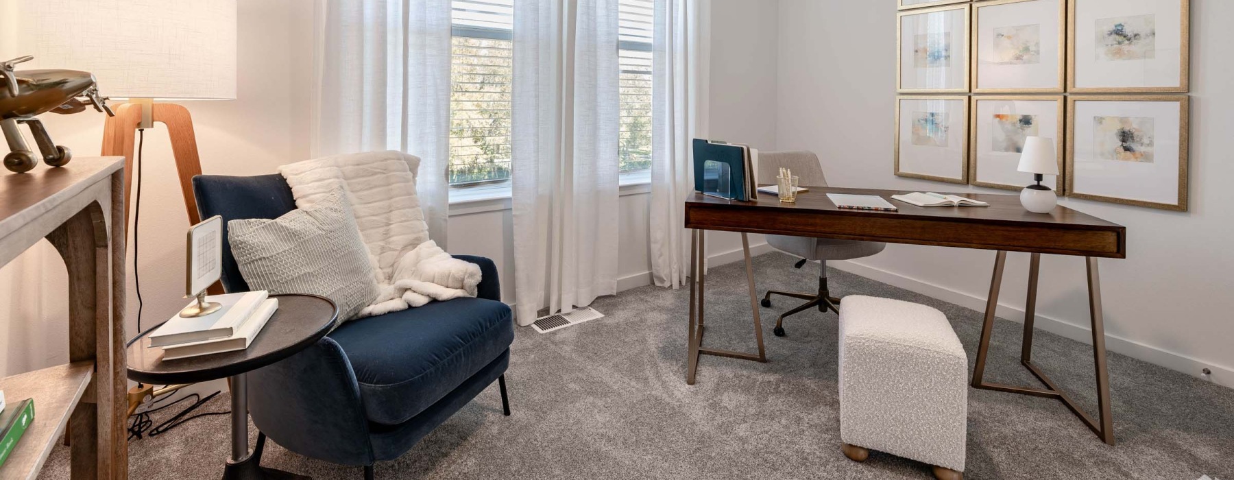 a room with a desk and chairs