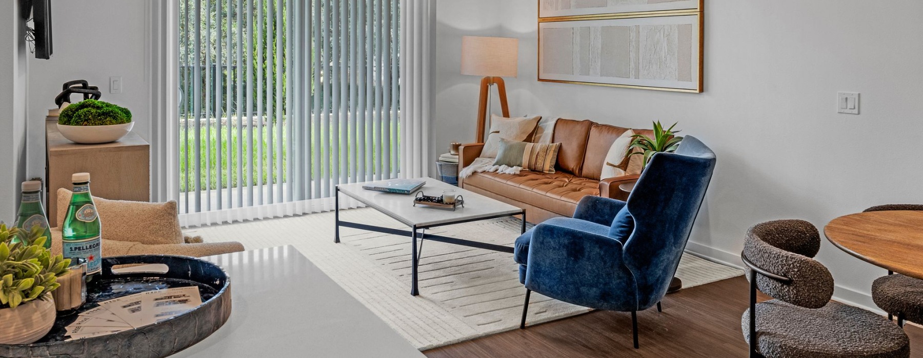 a living room with a blue chair and a table
