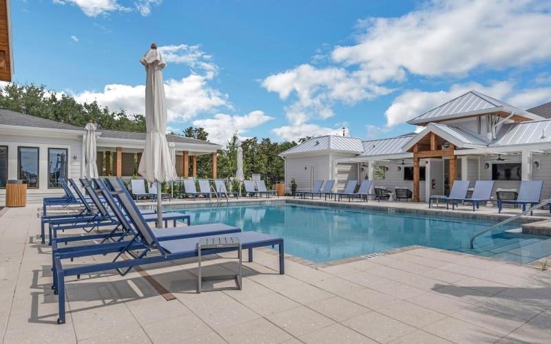 a swimming pool with a white umbrella